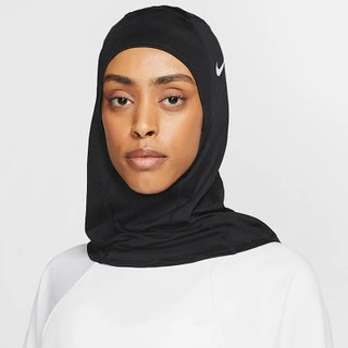 Nike Pro Hijab 2.0 model looking into the camera wearing black Nike hijab on white background